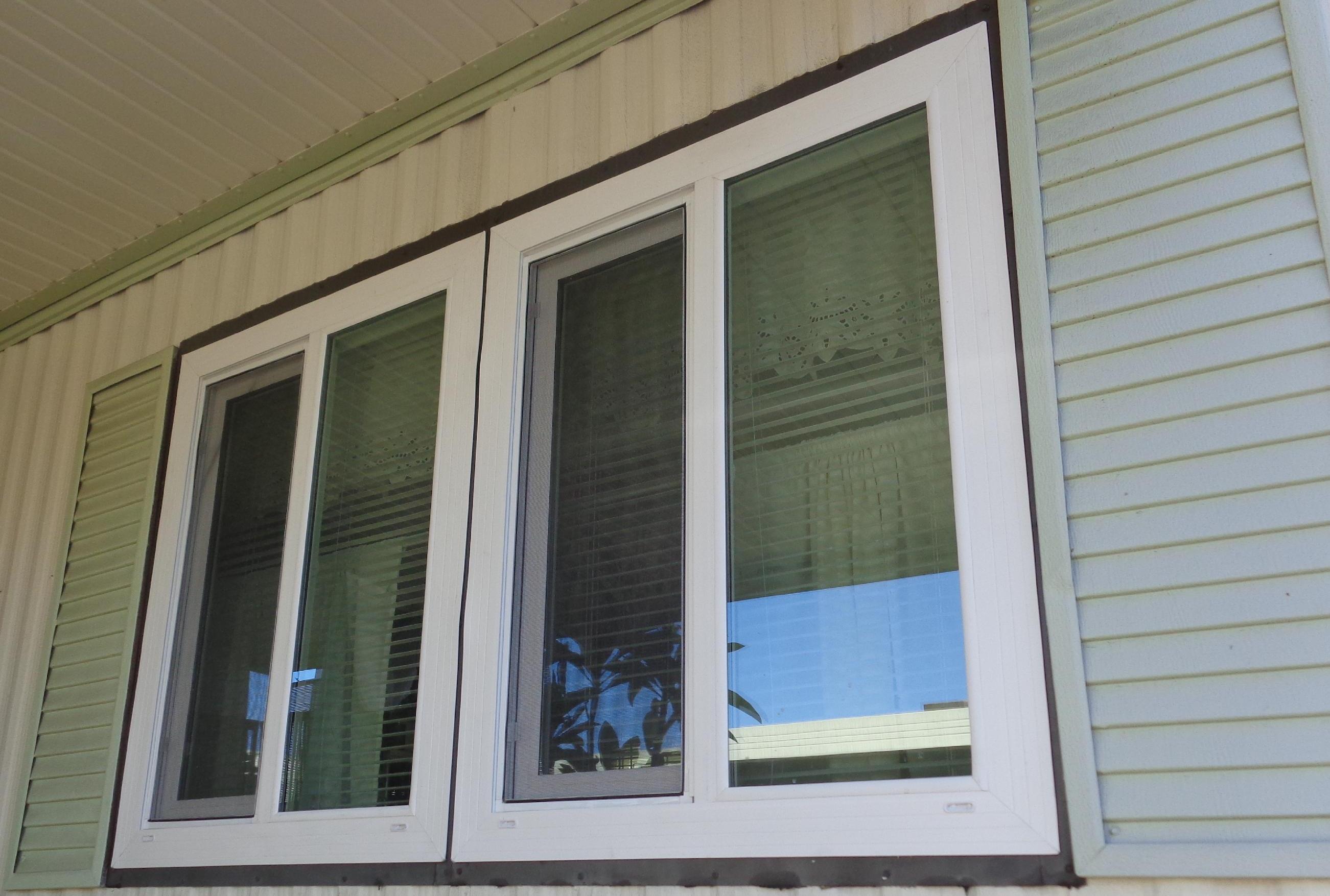 A house window with decorative shutters on either side